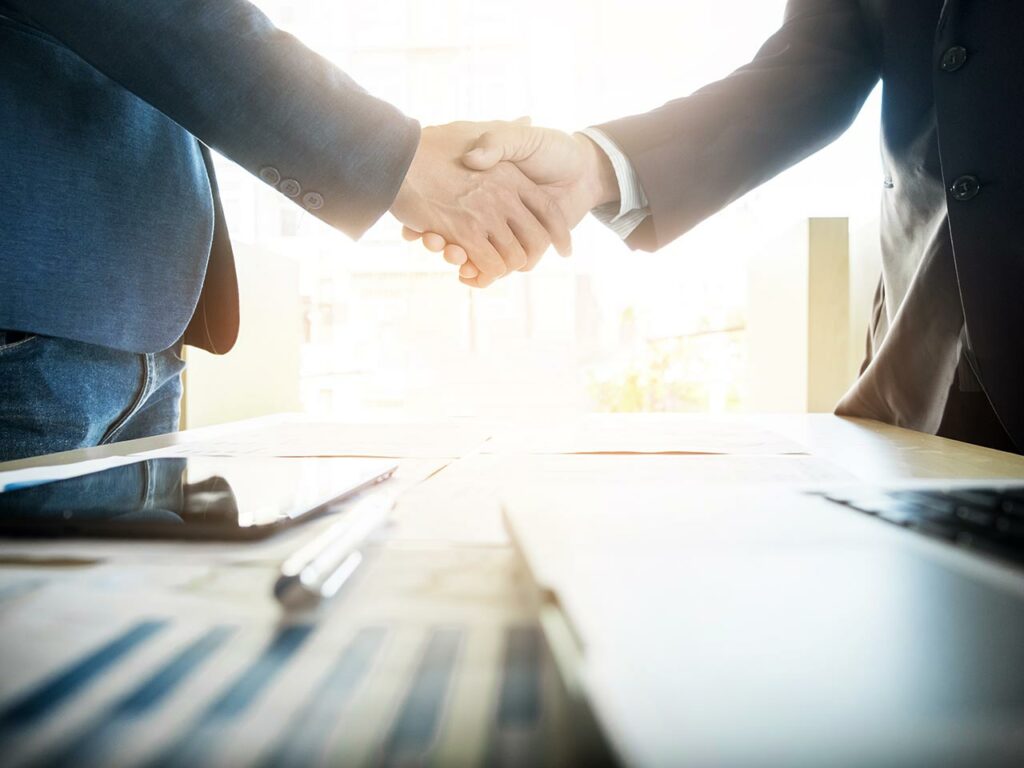 Business people shaking hands over a table
